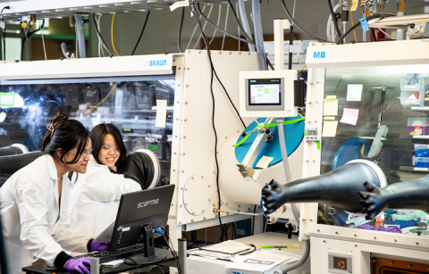 Two women looking at a computer in a lab