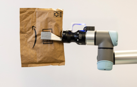 Robotic grasper holding an Amazon mailer